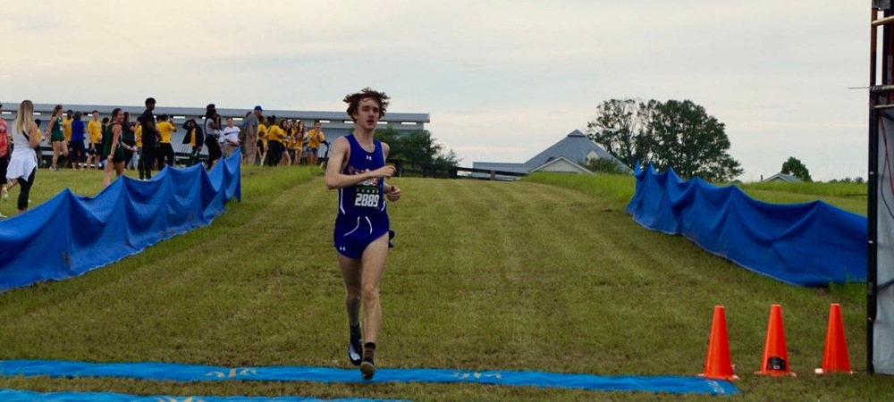 Leo Rutledge crosses the finish line at the Alligator Lake Invitational (photo courtesy of Adrian White)