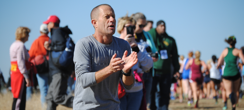 Cross country coach Gary Droze cheers on the Eagles at the NJCAA Cross Country Championships.